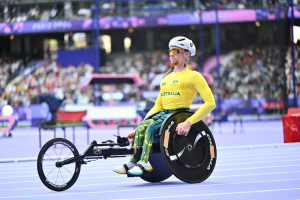luke bailey paralympian in his yellow and gold team uniform on the race track